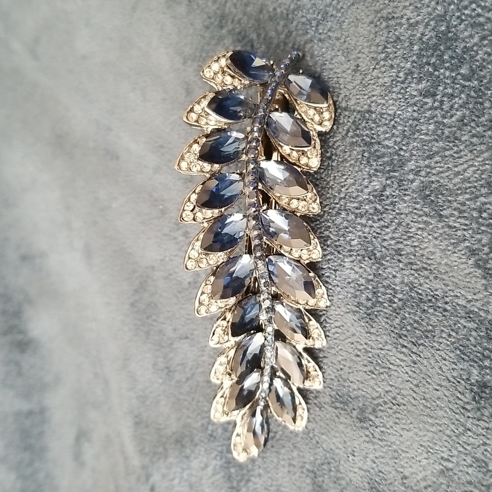 Hair accessory.  Black metal with blue stones and crystals.